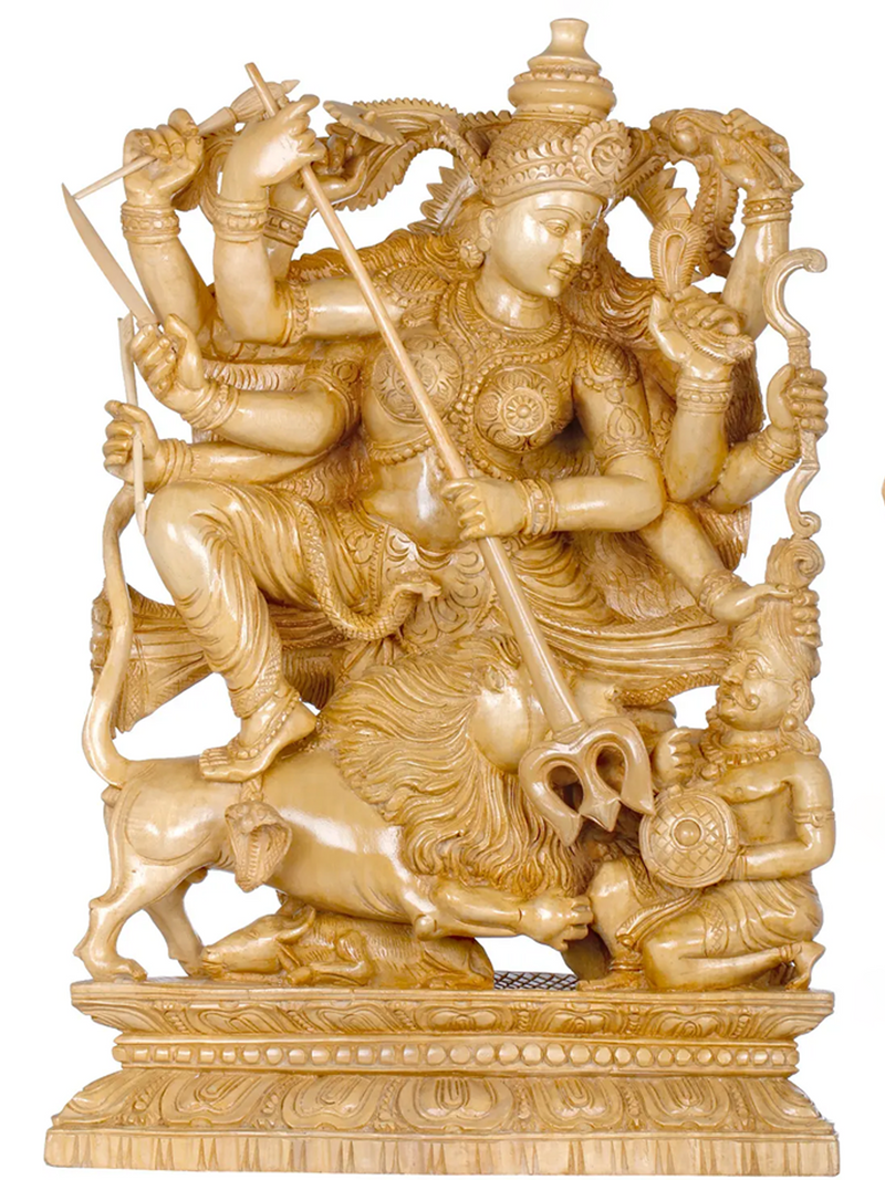 Carved stone statue of Durga with multiple arms and seated on lion