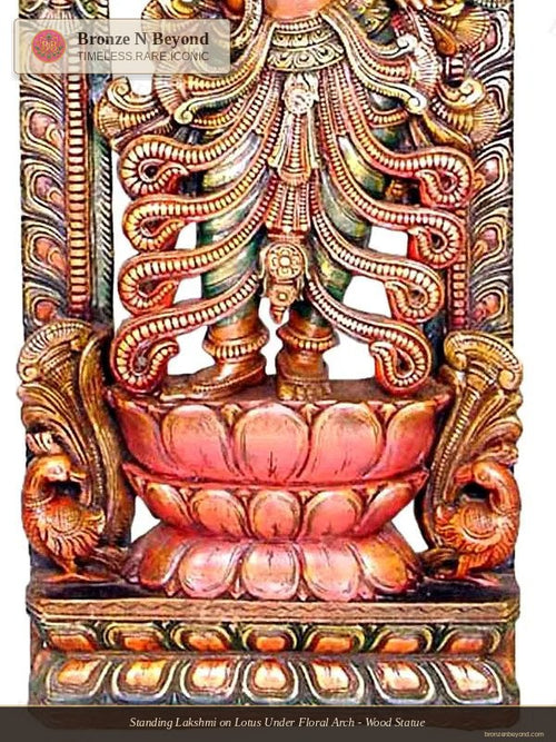 Standing Lakshmi on Lotus Under Floral Arch - Wood Statue