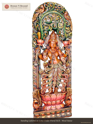 Standing Lakshmi on Lotus Under Floral Arch - Wood Statue
