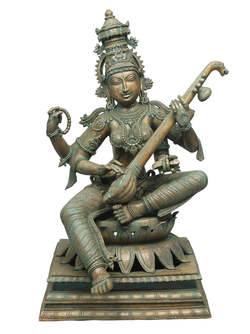 Bronze statue of Saraswati holding Veena