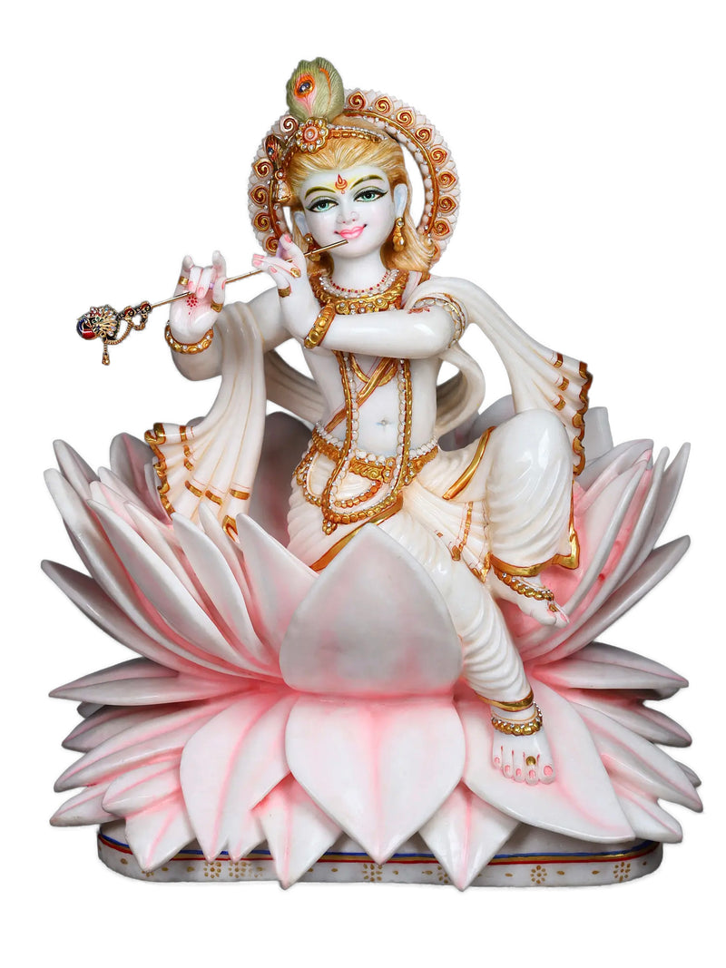 Decorative statue of Krishna on a pink lotus with gold accents